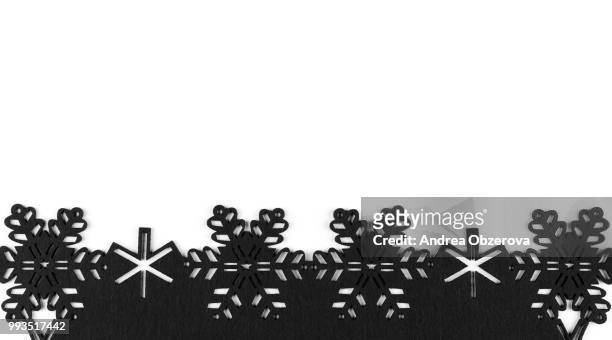 unusual design christmas background with black snowflakes and copy space on white background - black christmas stockfoto's en -beelden