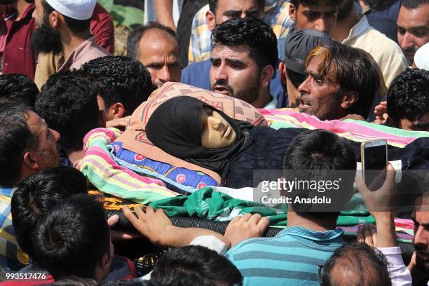 People carry the dead body of a teenage girl during her funeral in Kashmir, India on July 07, 2018. Three civilians were killed after Indian army...