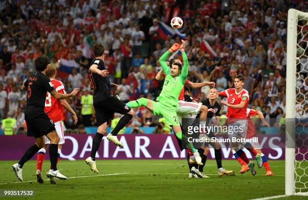Danijel Subasic of Croatia is fouled by Aleksandr Erokhin of Russia during the 2018 FIFA World Cup Russia Quarter Final match between Russia and...