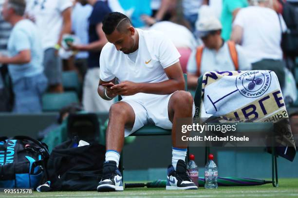 Nick Kyrgios of Australia checks his phone after losing against Kei Nishikori of Japan during their Men's Singles third round match on day six of the...