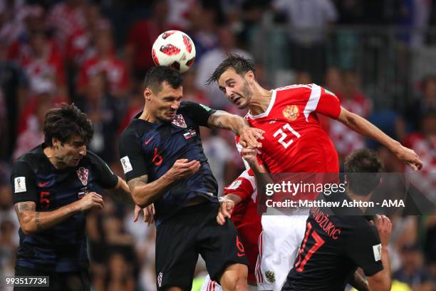 Dejan Lovren of Croatia competes with Aleksandr Erokhin of Russia during the 2018 FIFA World Cup Russia Quarter Final match between Russia and...