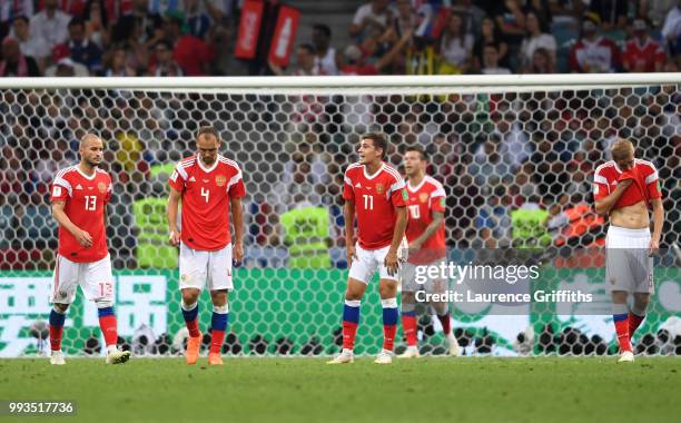 Fedor Kudriashov, Sergey Ignashevich, Aleksandr Golovin, Fedor Smolov and Iury Gazinsky of Russia walk away dejected after the second Croatia goal...