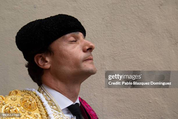 Spanish bullfighter Paco Urena looks closes his eyes as he prepares to perform on the second day of the San Fermin Running of the Bulls festival on...