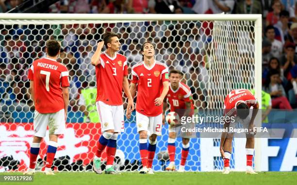 Daler Kuziaev, Ilya Kutepov, Mario Fernandes, Fedor Smolov and Aleksandr Erokhin of Russia walk away dejected after the second Croatia goal scored by...
