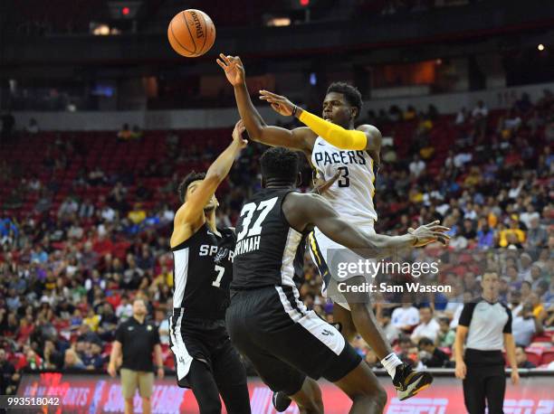 Aaron Holiday of the Indiana Pacers passes against Oliver Hanlan and Amida Brimah of the San Antonio Spurs during the 2018 NBA Summer League at the...