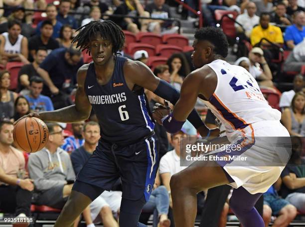 Johnathan Motley of the Dallas Mavericks drives to the basket against Deandre Ayton of the Phoenix Suns during the 2018 NBA Summer League at the...