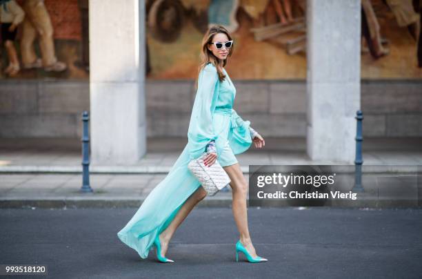 Alexandra Lapp wearing a long shine through dress in turquoise by Lana Mueller, a 2.55 silver handbag by Chanel, two tone Mahnolo Blahnik heels in...