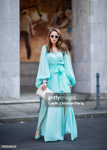 Alexandra Lapp wearing a long shine through dress in turquoise by Lana Mueller, a 2.55 silver handbag by Chanel, two tone Mahnolo Blahnik heels in...