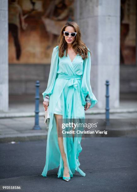 Alexandra Lapp wearing a long shine through dress in turquoise by Lana Mueller, a 2.55 silver handbag by Chanel, two tone Mahnolo Blahnik heels in...