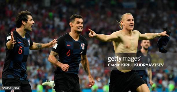 Croatia's defender Domagoj Vida celebrates with teammates after scoring a goal during the extra time of the Russia 2018 World Cup quarter-final...