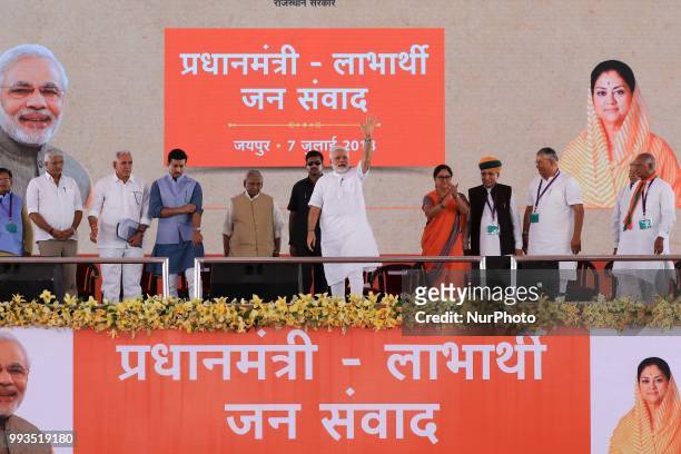 Prime Minister Narendra Modi with Rajasthan Chief Minister Vasundhara Raje during a public meeting for the beneficiaries of various welfare schemes...