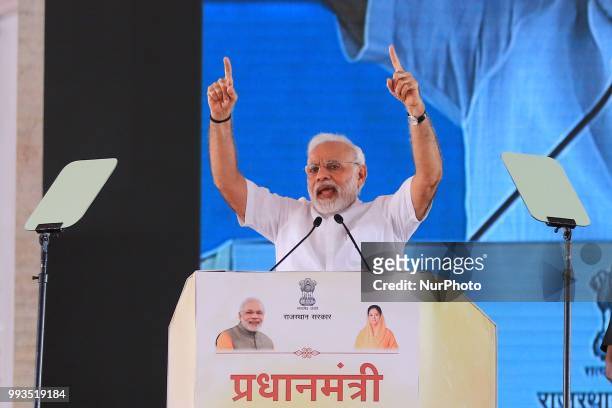 Prime Minister Narendra Modi speaks during a public meeting for the beneficiaries of various welfare schemes of the BJP government, in Jaipur,...