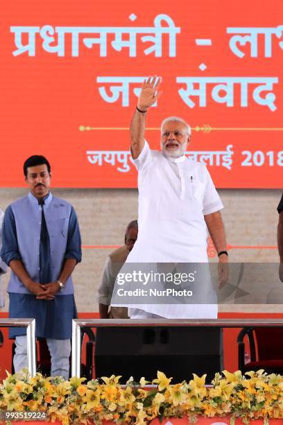 Prime Minister Narendra Modi waves during a public meeting for the beneficiaries of various welfare schemes of the BJP government, in Jaipur,...