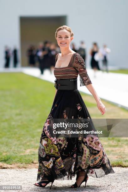 Kate Bosworth wears a black lace dress with colored embroidery , outside Dior, during Paris Fashion Week Haute Couture Fall Winter 2018/2019, on July...