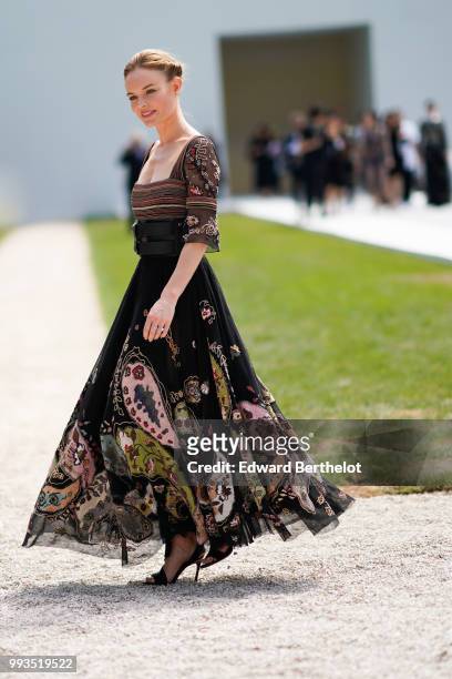 Kate Bosworth wears a black lace dress with colored embroidery , outside Dior, during Paris Fashion Week Haute Couture Fall Winter 2018/2019, on July...