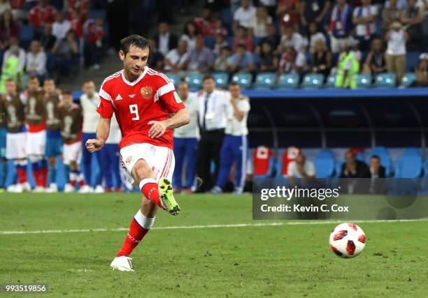 Alan Dzagoev of Russia scores his team's second penalty in the penalty shoot out during the 2018 FIFA World Cup Russia Quarter Final match between...