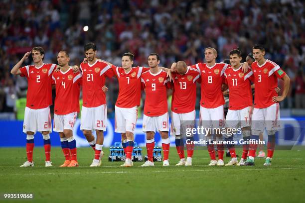 Players from Russia look on from the half way line during the penalty shoot out during the 2018 FIFA World Cup Russia Quarter Final match between...