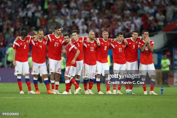 Players from Russia look on from the half way line during the penalty shoot out during the 2018 FIFA World Cup Russia Quarter Final match between...