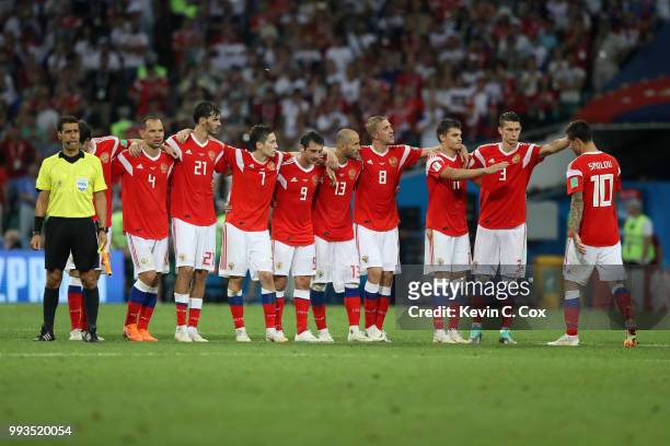 Fedor Smolov of Russia is consoled by teammates as they look on from the half way line during the penalty shoot out during the 2018 FIFA World Cup...
