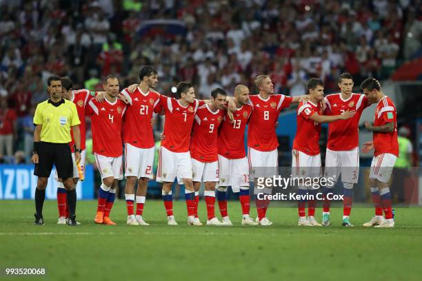 Fedor Smolov of Russia is consoled by teammates as they look on from the half way line during the penalty shoot out during the 2018 FIFA World Cup...