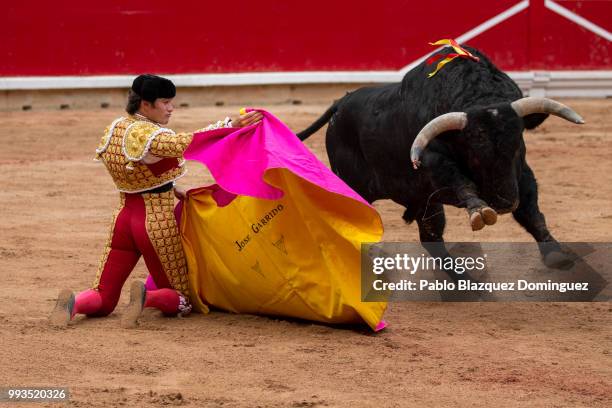 Spanish bullfighter Jose Garrido performs with a bull from Puerto de San Lorenzo's fighting bulls during a bullfight on the second day of the San...