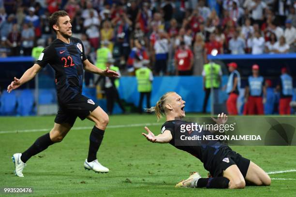 Croatia's defender Domagoj Vida and Croatia's defender Josip Pivaric celebrate their winning penalty during the Russia 2018 World Cup quarter-final...