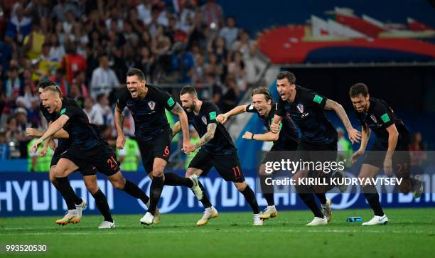 Croatia's players celebrate winning the penalty shootout during the Russia 2018 World Cup quarter-final football match between Russia and Croatia at...