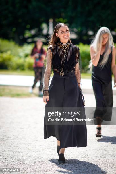 Olivia Palermo wears a black lace mesh dress, a necklace , outside Dior, during Paris Fashion Week Haute Couture Fall Winter 2018/2019, on July 2,...