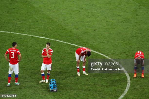 Ilya Kutepov, Daler Kuziaev, Aleksandr Erokhin and Sergey Ignashevich of Russia show their dejection following the defeat in the 2018 FIFA World Cup...