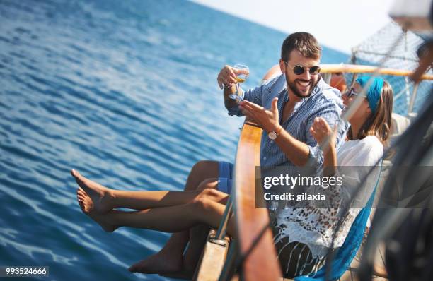 couple on a sailboat. - gilaxia stock pictures, royalty-free photos & images