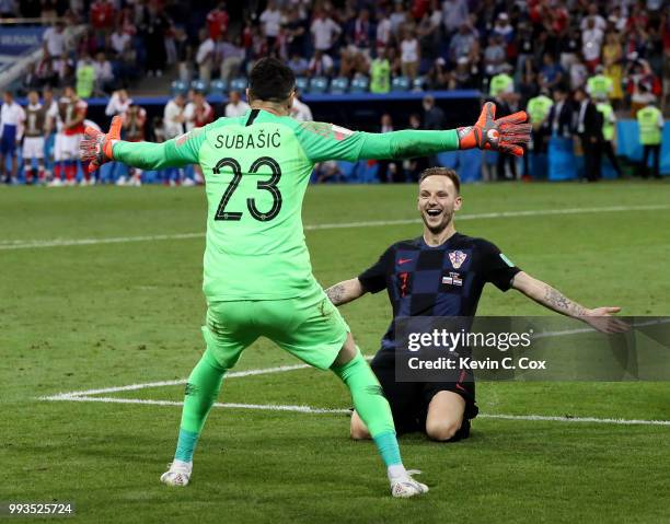 Ivan Rakitic of Croatia celebrates with Danijel Subasic of Croatia after he scores his team's fifth penalty, the winning penalty, in the penalty...