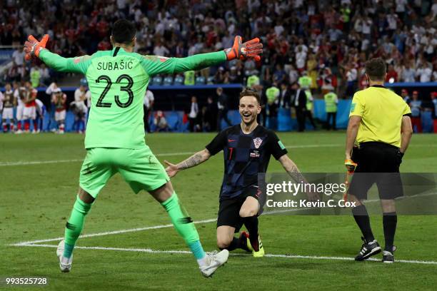 Ivan Rakitic of Croatia celebrates with Danijel Subasic of Croatia after he scores his team's fifth penalty, the winning penalty, in the penalty...