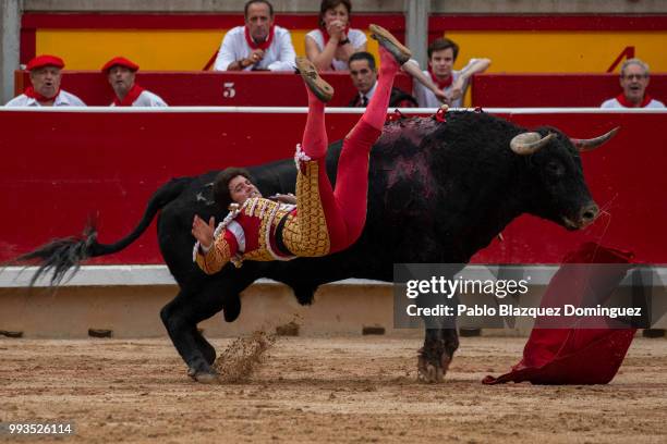 Spanish bullfighter Jose Garrido is tossed as he tried to kill a bull from Puerto de San Lorenzo's fighting bulls during a bullfight on the second...