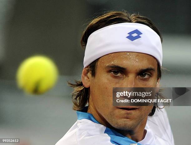 David Ferrer of Spain returns a ball to British Andy Murray during their Madrid Masters tennis match on May 14, 2010 at the Caja Magic sports complex...