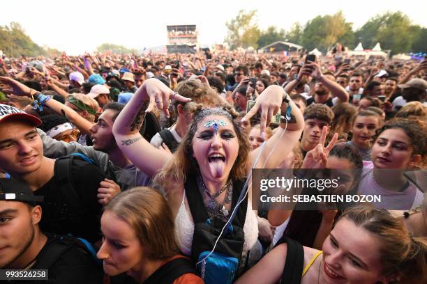 People attend the concert of Belgian singer Damso during the 30th Eurockeennes rock music festival on July 7, 2018 in Belfort, eastern France.