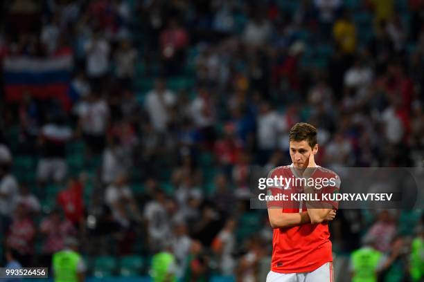 Russia's midfielder Daler Kuzyaev reacts after the team lost the Russia 2018 World Cup quarter-final football match between Russia and Croatia at the...