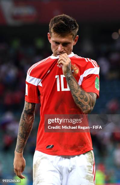 Fedor Smolov of Russia walks off the pitch dejected follwing his team's defeat in the 2018 FIFA World Cup Russia Quarter Final match between Russia...