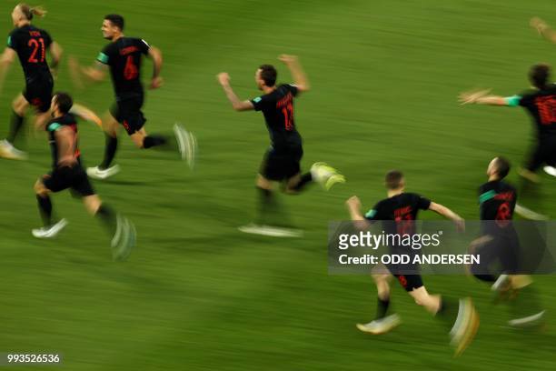 Croatia's players celebrate at the end of the penalty shootouts of the Russia 2018 World Cup quarter-final football match between Russia and Croatia...