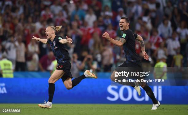 Domagoj Vida and Dejan Lovren of Croatia celebrate their victory after the extra time penalty shoot-out during the 2018 FIFA World Cup Russia Quarter...