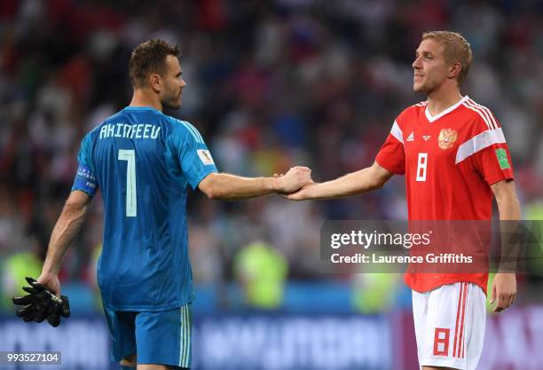 Igor Akinfeev and Iury Gazinsky of Russia walk off dejected following the 2018 FIFA World Cup Russia Quarter Final match between Russia and Croatia...