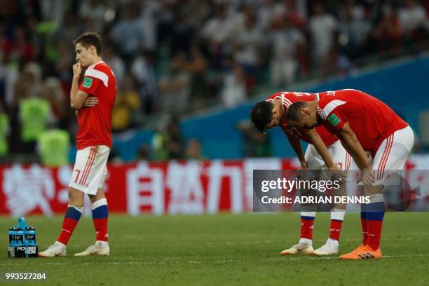 Russia's players react to their loss during the Russia 2018 World Cup quarter-final football match between Russia and Croatia at the Fisht Stadium in...