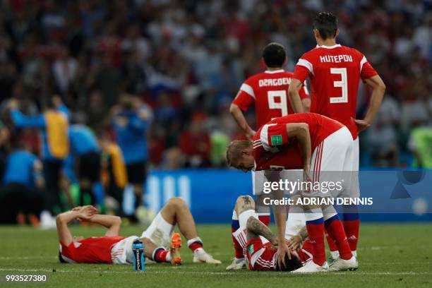 Russia's players react to their loss during the Russia 2018 World Cup quarter-final football match between Russia and Croatia at the Fisht Stadium in...