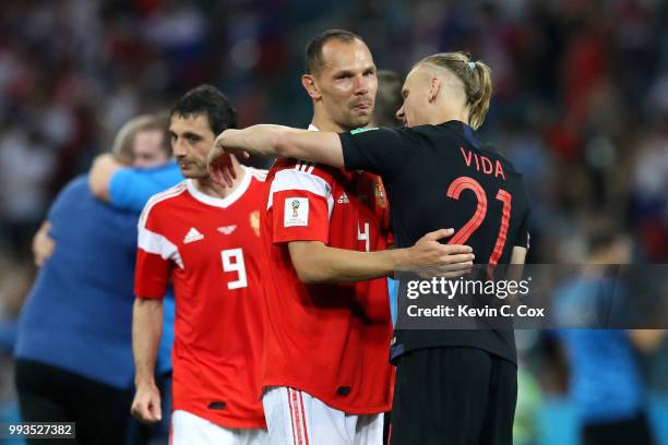 Sergey Ignashevich of Russia is consoled by Domagoj Vida of Croatia follwing the 2018 FIFA World Cup Russia Quarter Final match between Russia and...