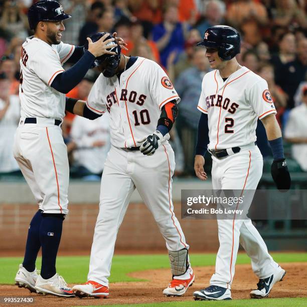 Yuli Gurriel of the Houston Astros celebrates with Alex Bregman and George Springer after hitting a three-run home run in the third inning against...