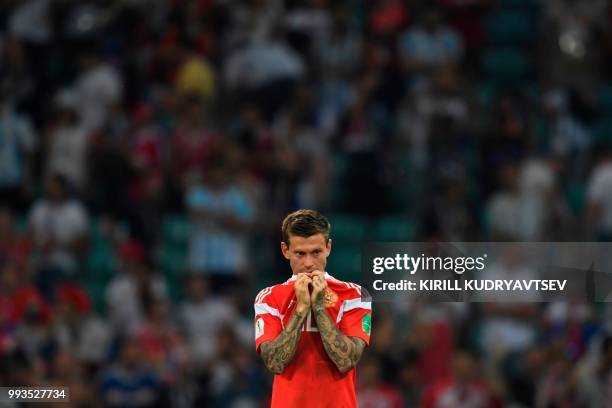 Russia's forward Fedor Smolov reacts after the team lost the Russia 2018 World Cup quarter-final football match between Russia and Croatia at the...