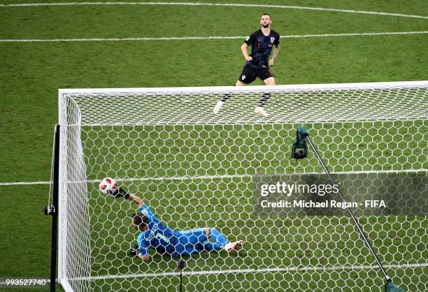 Igor Akinfeev of Russia saves the second penalty from Mateo Kovacic of Croatia in the penalty shoot out during the 2018 FIFA World Cup Russia Quarter...