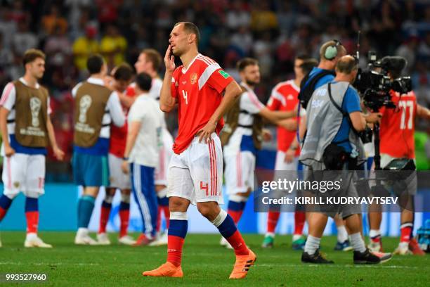 Russia's defender Sergey Ignashevich reacts after the team lost the Russia 2018 World Cup quarter-final football match between Russia and Croatia at...