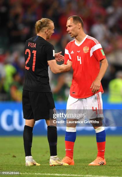 Sergey Ignashevich of Russia coingratulates Domagoj Vida of Croatia following the 2018 FIFA World Cup Russia Quarter Final match between Russia and...