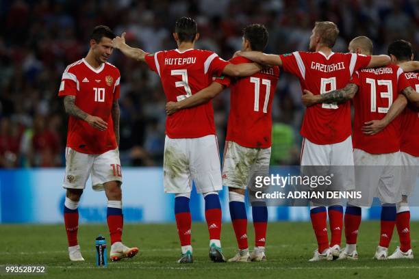 Russia's forward Fedor Smolov reacts after missing a penalty during the Russia 2018 World Cup quarter-final football match between Russia and Croatia...