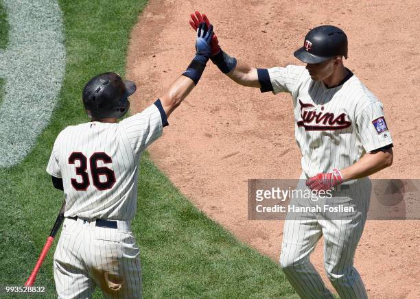 Robbie Grossman of the Minnesota Twins congratulates teammate Max Kepler on a solo home run against the Baltimore Orioles during the fifth inning of...